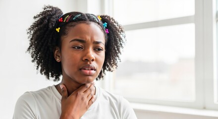 Black woman touching her neck in pain due to a sore throat. Sick African American teenager feeling unwell with flu symptoms. Healthcare concept