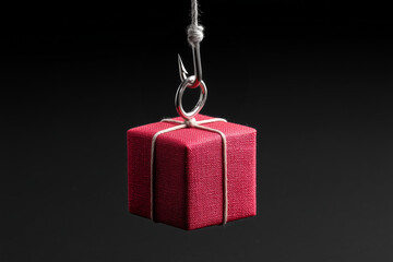 a red gift box hanging on the end of a fishing hook, isolated on a grey background, Shopaholism concept
