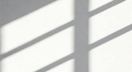 Shadows cast by window blinds creating geometric patterns on a textured white wall, evoking a minimalist ambiance