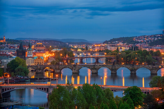 Scenic night view of Prague bridges at twilight. Manes, Charles, Legion, Jirasek and Palacky bridges across the Vltava river. Downtown of Prague city, Czech Republic