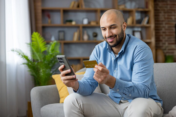 Man buying online using smartphone and credit card
