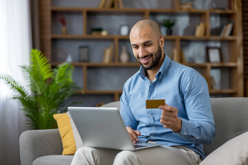 Man shopping online using laptop and credit card