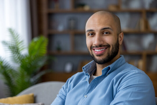 Happy man smiling, feeling confident and relaxed at home - Powered by Adobe