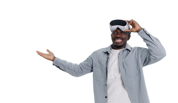 Happy African male adult exploring virtual reality with vr headset on white background - Powered by Adobe