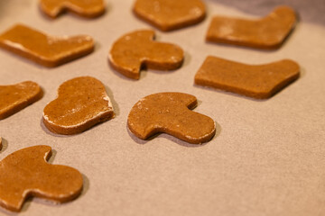 Gingerbread Hearts, Mushrooms and Boots on Baking Paper – Horizontal Close-Up