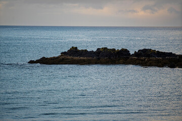 Rocky islet in calm coastal waters, Akranes, Iceland