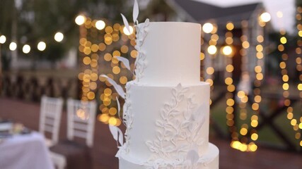 White wedding cake on a white table