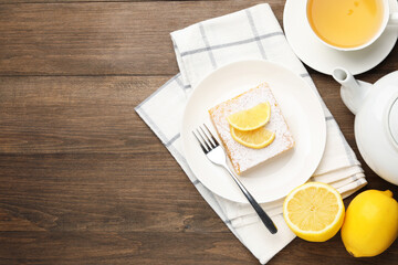 Tasty lemon bar with powdered sugar served on wooden table, flat lay. Space for text