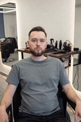 Portrait of customer man after a haircut in style barbershop. Bearded Man client visit gentleman grooming beauty salon for hairstyle care. Male skin care and beard style concept. 