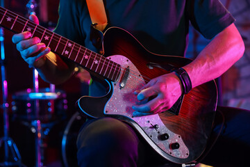 Naklejka premium Man playing electric guitar on stage, closeup