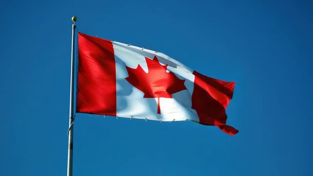 The Canadian flag waving high against a blue sky with minimal text watermark