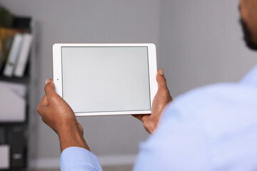 African-american man using tablet in office, closeup