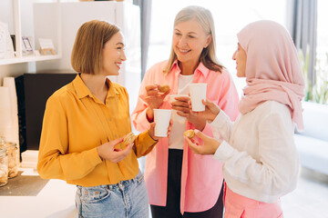 Diverse smiling happy group of multinational women, one female wearing stylish hijab