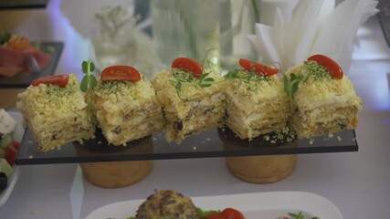 Beautifully arranged desserts sit on an elegant table at a special event. The colorful cakes and treats showcase artistic designs that tempt every guest. Each creation is a visual delight.