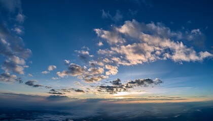 Fototapeta premium a few clouds drifted through the sky creating patterns that add beauty to the sky the dynamic nature of clouds in the sky invites contemplation and appreciation of the sky s artistry