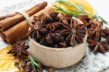 Different spices, dry orange slices and fresh rosemary for mulled wine on table, closeup