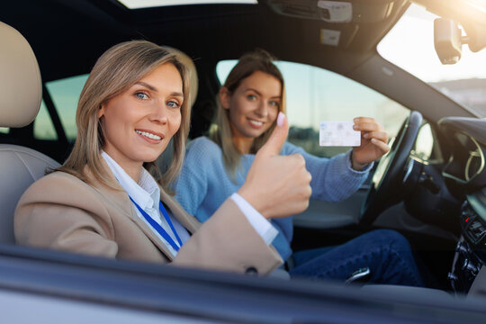 Driving Student and Instructor Celebrating Successful License Test