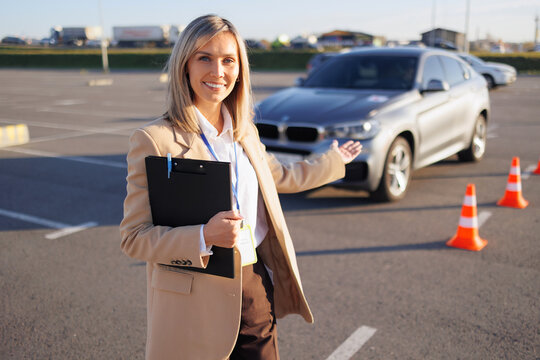 Driving Instructor Presenting Training Car and Course Cones