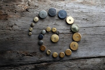 Vintage Brass Button Collection Arranged in a Spiral Pattern for Antique Crafts and Historical Sewing