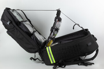 Open  extra large tactical sanitary rescue backpack, inside transparent pockets with tablets, syringes and dressing material.