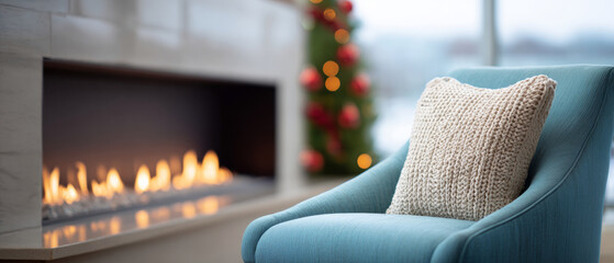 A cozy living room with a lit fireplace and blue armchair, decorated for the holidays