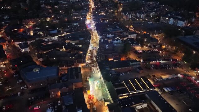 Aerial elevated drone video capture of Alton High Street in Alton, UK on the night of the Christmas lights 'switch on' 2025.