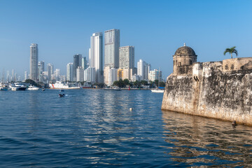 Modern high rise buildings and historical fort walls in Cartagena city harbour, Colombia