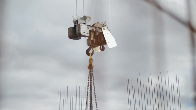 Construction Crane Hook with Chains at Building Site