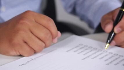 To-Do List and Task List Concept. Close-up businessman checks or marks with pen on a checklist, checkbox, to-do list box after completing a task on a white paper. 
 - Powered by Adobe