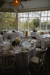 A large room with tables and chairs, and a cake on a table