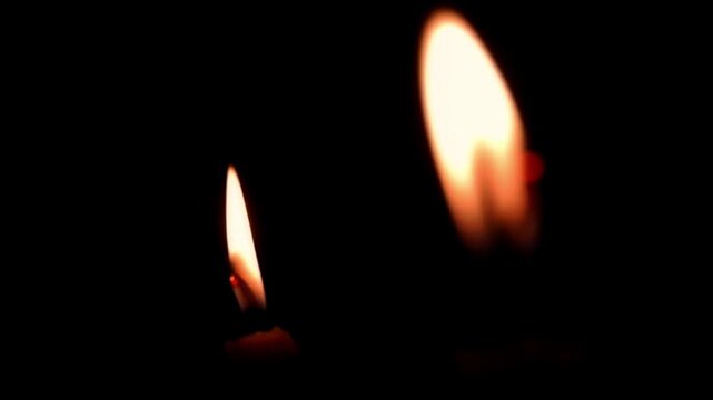 A candle burning in the dark, without electricity, darkness, ritual. Night space glowing softly with flickering light. Calm reflective mood.