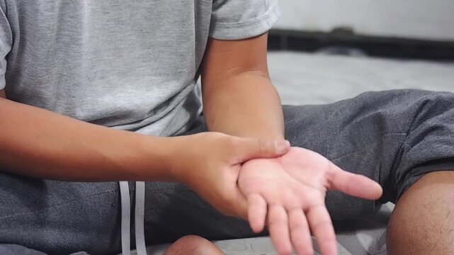 Wrist pain. Closeup of a man's arm holding and massaging his painful wrist due to prolonged use of a computer or laptop. Syndrome, arthritis, neurological disease concept. Numbness in the hand.
