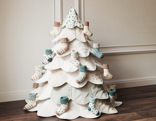 Fabric Christmas Tree with Top Star and Cute Baby Socks Decorated in a Room, Generative AI