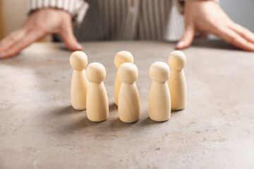 Woman with human figures at light table, closeup