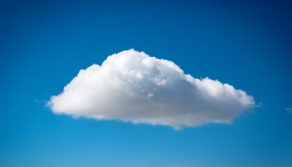 a single cumulus cloud floating in a clear blue sky on a bright sunny day with soft light and shadows