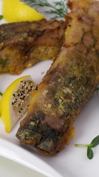 Fried fish lemons breaded fish with dipping sauce and lemon