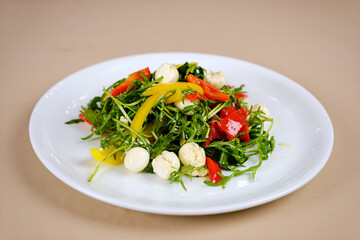 A bowl of colorful salad in a white ceramic bowl top down view isolated. High quality photo