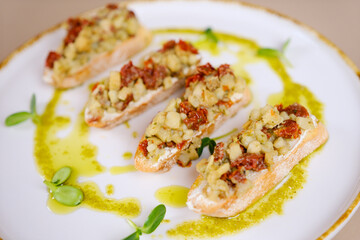 This bruschetta features a delicious combination of fresh mozzarella and tomatoes with pesto. High quality photo