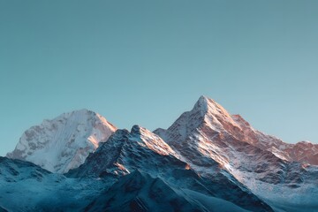 Fototapeta premium Snow capped mountains against a tranquil blue sky during golden hour