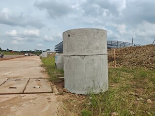 an abandoned concrete pipe on a quiet road, this concrete pipe is the remains of the construction of a large factory in a place in Indonesia.