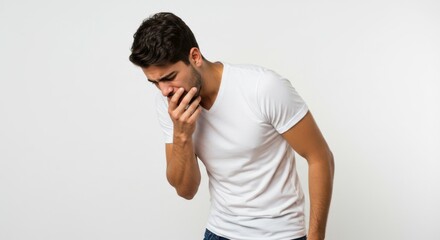 Young man experiencing nausea, potentially from illness or food poisoning looks unwell