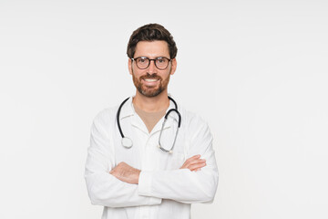 Portrait of doctor, general practitioner, physician, medical professional wearing white uniform coat and stethoscope, posing with folded arms and smiling isolated on white studio background