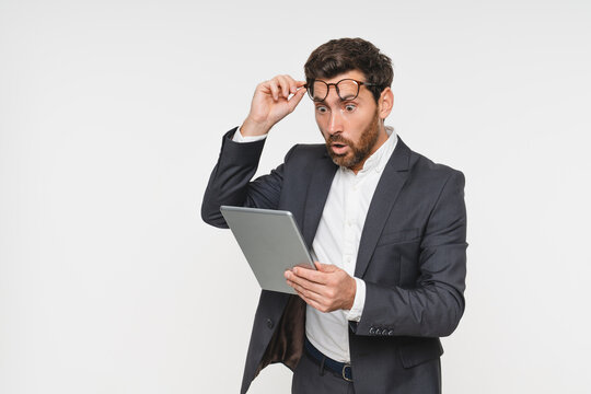 Shocked business man with tablet, technology or corporate communication isolated on studio background. Internet, connectivity or networking professional, male worker or check email on mockup space