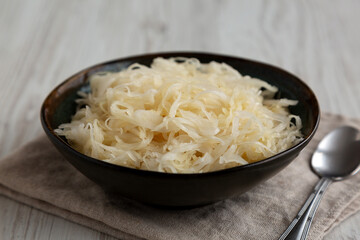 Organic White German Sauerkraut in a Bowl, side view. Close-up.