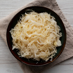 Organic White German Sauerkraut in a Bowl, top view. Close-up.