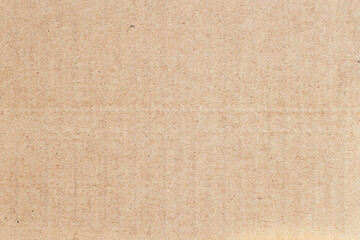 Fototapeta premium Flat recycled cardboard texture with visible natural fibers and neutral color tone. Natural background for eco-friendly design, copy space