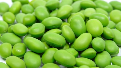 Fresh green edamame soybeans creating a vibrant background texture, representing healthy vegetarian food, plant based protein, organic farming, and sustainable nutrition
