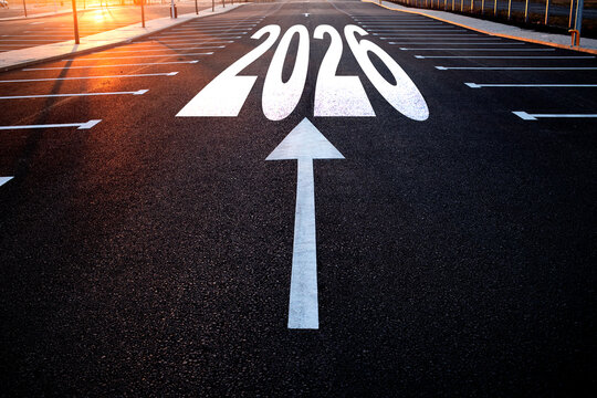 whiite arrow and 2026 written on concrete - Powered by Adobe