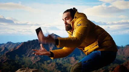 Foolish hiker acting careless dropping smartphone and losing balance, person unequipped for the harsh mountain environment. Risks of trekking with a technology obsession in nature. Camera A.