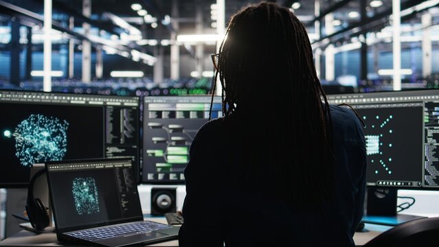 Server hub technician arriving in office, using AI visualization insights on PC to optimize system health. Data center IT specialist using computer node tree software to analyze gear issues, camera A - Powered by Adobe